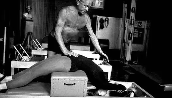 Joseph Pilates demonstrating exercises in the early 20th century