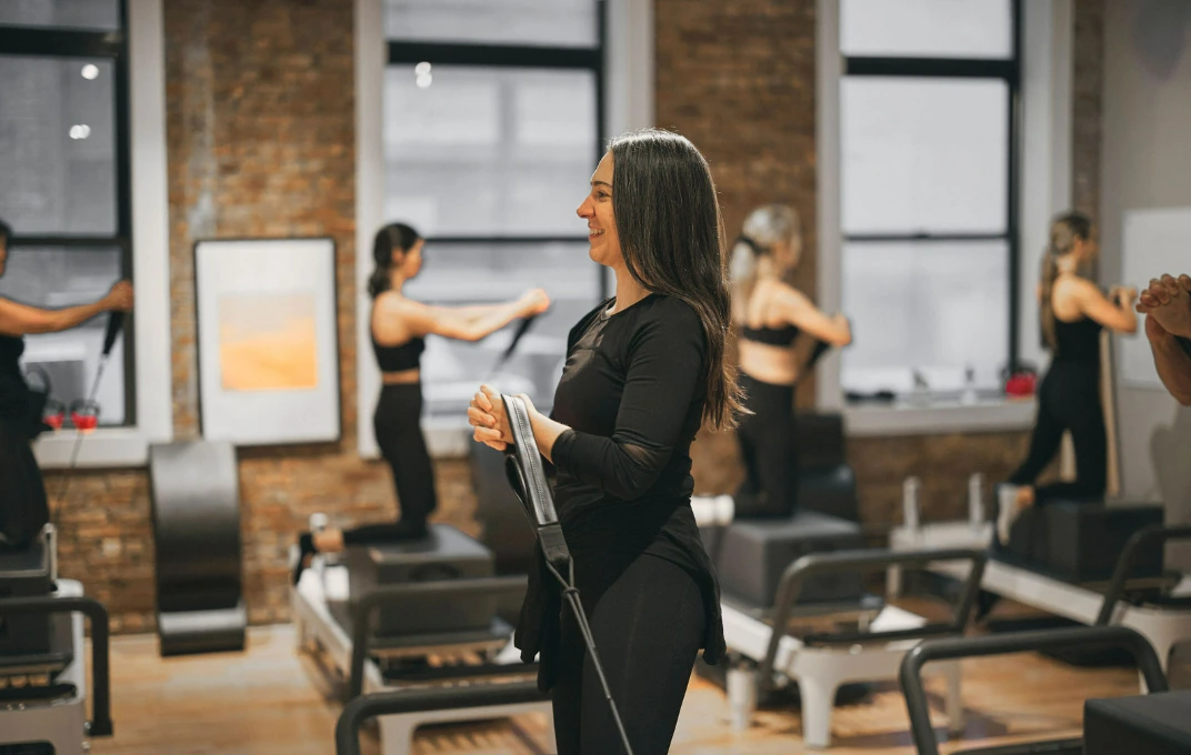 BK Pilates instructor guiding clients through focused movement during an express 30 minute Pilates session