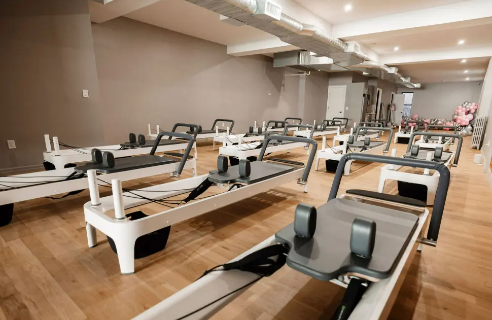 An empty Pilates studio with a festive balloon arrangement, showing the welcoming and professional environment at BK Pilates for all fitness levels.