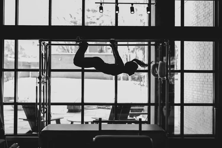 Professional instructor leading a pilates reformer session at BK Pilates Raleigh