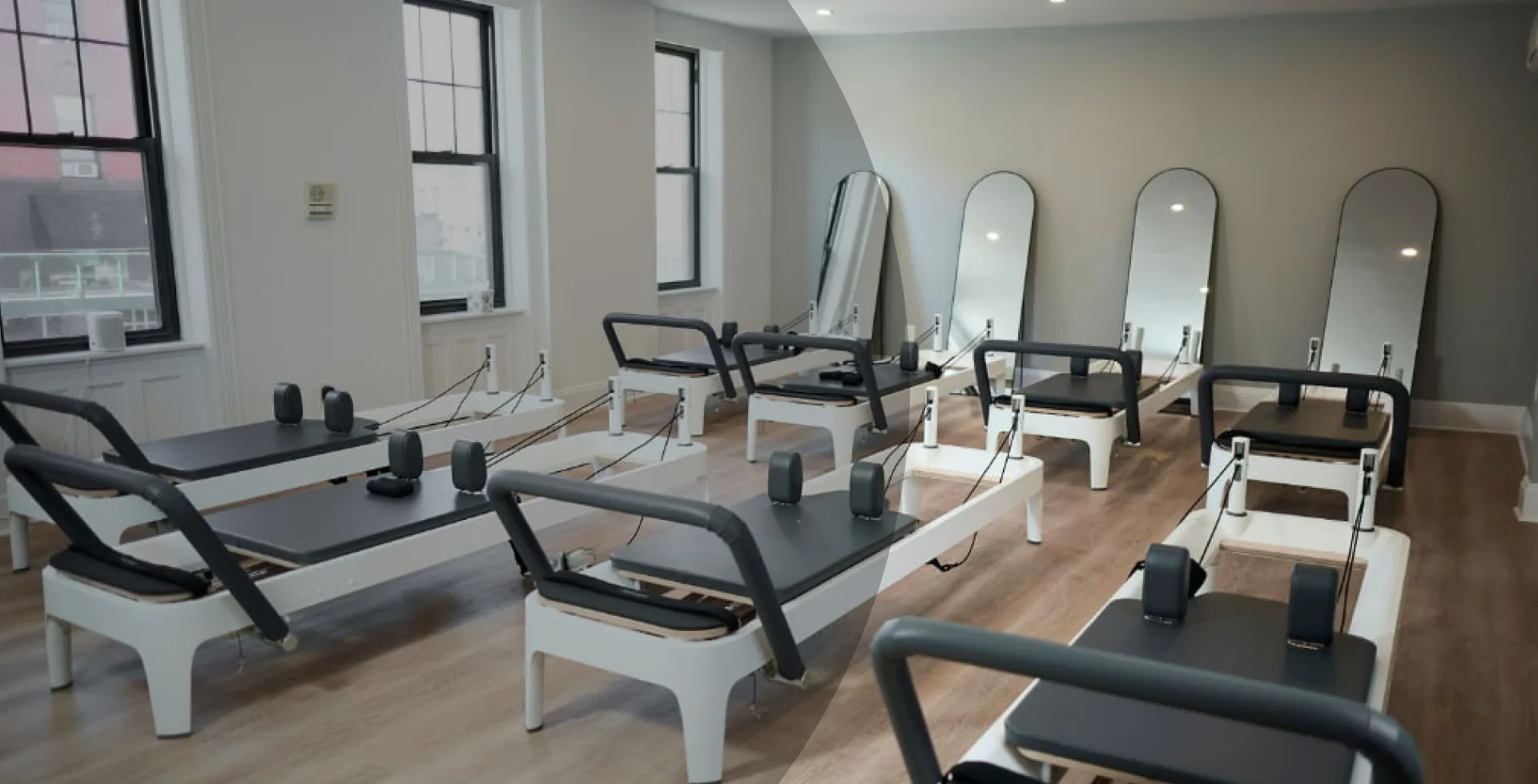Modern reformer pilates studio interior at BK Pilates Concord with professional equipment and wooden floors