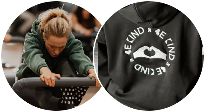 Two circular inset images side-by-side: on the left, a blonde woman in a green hoodie performs a Pilates reformer stretch at BK Pilates South End, and on the right, a close-up of the back of a black hoodie with an embroidered white logo featuring a hand-heart gesture and the text "BE KIND" repeated around it