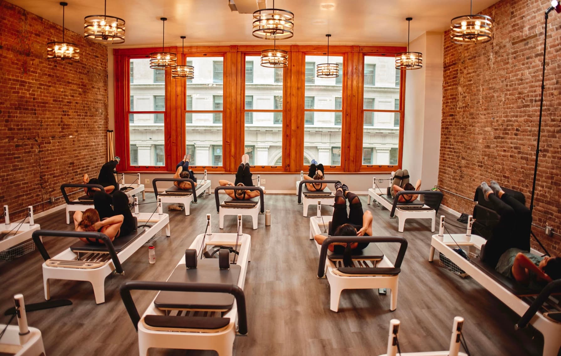 Full reformer Pilates studio at BK Pilates, showing the equipment used to compare mat vs reformer Pilates