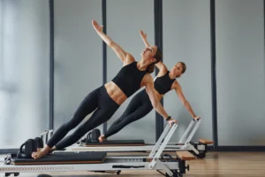women-doing-pilates-exercises-on-exercise-machines