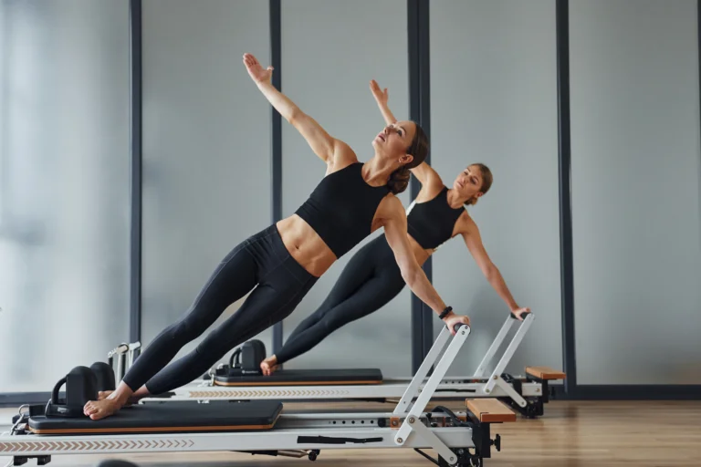 women-doing-pilates-exercises-on-exercise-machines